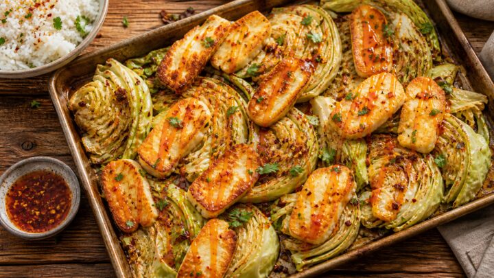 Hot honey halloumi cabbage sheet pan bowls with roasted cabbage wedges and golden halloumi drizzled with spicy honey sauce, served over rice.