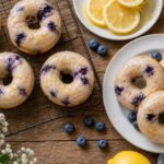 Moist blueberry lemon olive oil baked donuts with lemon glaze on a wire rack