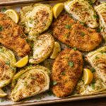 Cabbage schnitzel chicken sheet pan dinner with breaded chicken cutlets and roasted cabbage wedges on a baking sheet