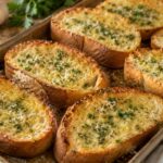 Easy homemade garlic bread served warm on a baking sheet with golden edges and melted butter.