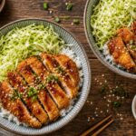 Air fryer chicken katsu cabbage bowls with crispy chicken strips, shredded cabbage, and rice drizzled with katsu sauce