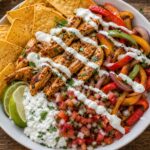 Chicken Fajita Cottage Cheese Nacho Bowls topped with peppers and fresh cilantro